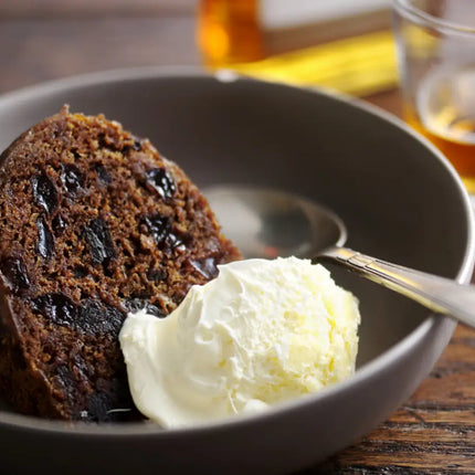 Traditional Scottish Clootie Pudding sliced and served with custard