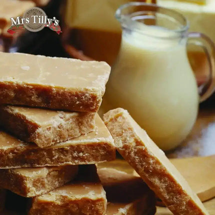 Scottish fudge, tablet pieces, and chocolate bars arranged on a wooden board