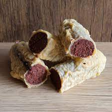 Traditional Scottish red pudding sliced and served with chips