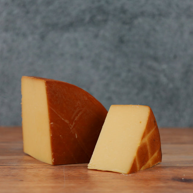 Selection of Scottish smoked cheese wedges on a wooden cheeseboard