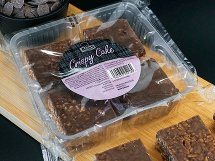 Packaged Crispy Cake on a wooden board with a dark background