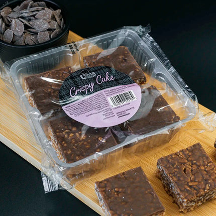 Packaged Crispy Cake on a wooden board with a dark background