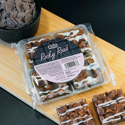 Packaged Rocky Road dessert on a wooden board with a black background