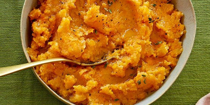 Traditional Scottish swede neeps mashed with butter served alongside haggis and tatties