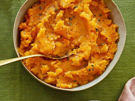 Traditional Scottish swede neeps mashed with butter served alongside haggis and tatties