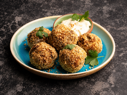Vegetarian haggis bon bons served on a turquoise plate with a dip – serving suggestion